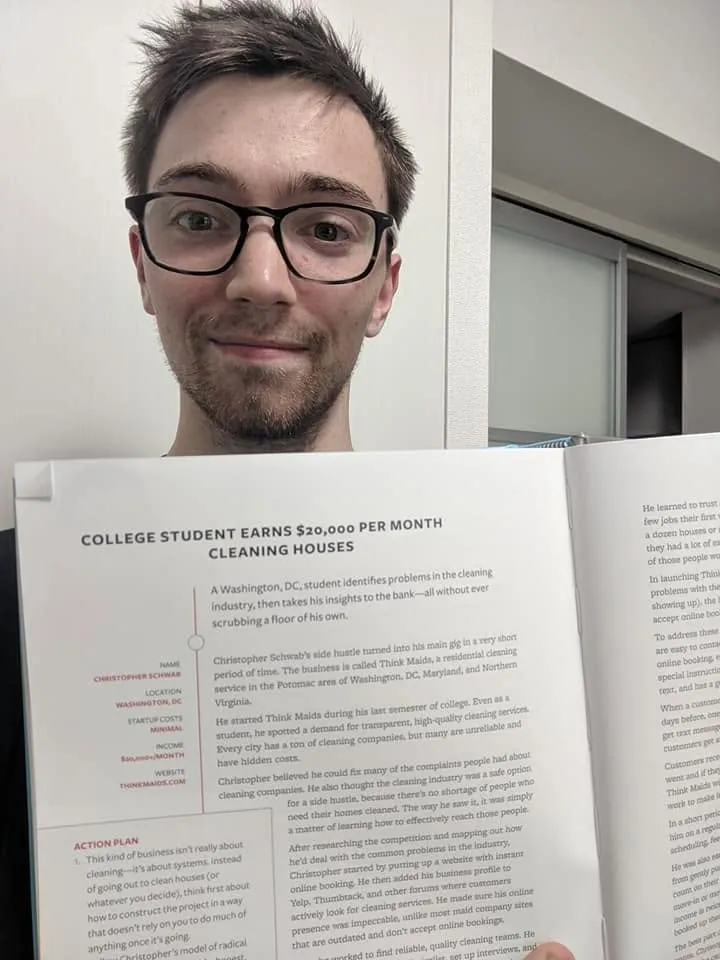 Chris holding 100 Side Hustles open at his two-page story