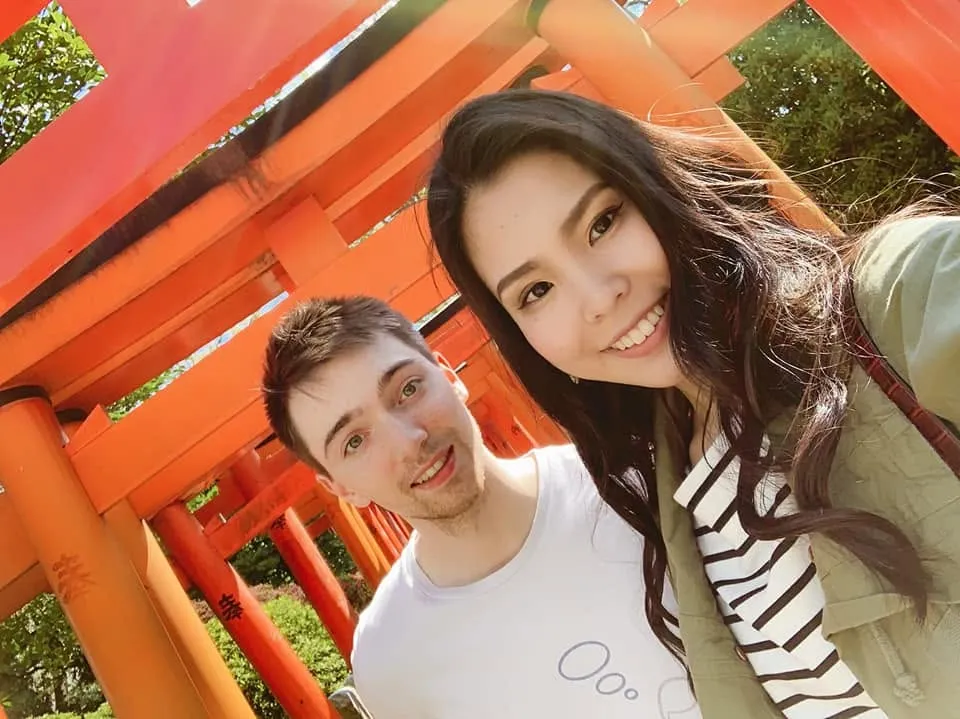 Chris and his wife under the vermilion torii gates in Japan